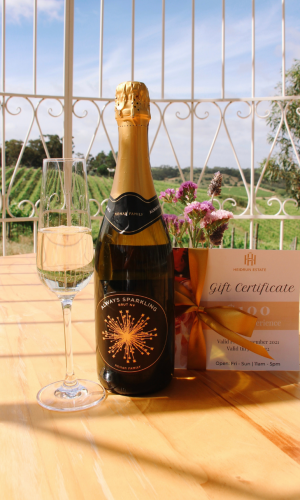 gold and black sparkling wine bottle with gift certificate